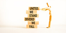 United Or Divided Symbol. Concept Words United We Stand Divided We Fall On Wooden Blocks. Beautiful White Table White Background. Businessman Icon. Business United Or Divided Concept. Copy Space.