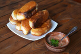 Fototapeta Tulipany - Fried homemade sausage pies served with tomato savoury sauce with fresh chopped dill