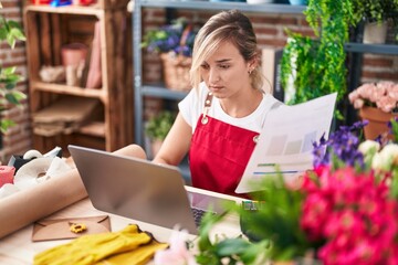 Sticker - Young blonde woman florist using laptop reading document at florist