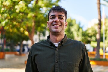 Canvas Print - Young hispanic man smiling confident standing at park