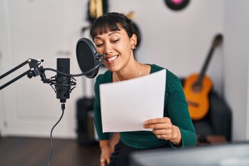 Sticker - Young beautiful hispanic woman musician smiling confident singing song at music studio