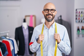 Canvas Print - Young bald man tailor smiling confident standing at tailor shop