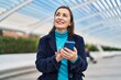© Krakenimages.com - Middle age woman business executive using smartphone at street