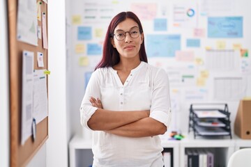 Wall Mural - Young beautiful hispanic woman business worker smiling confident standing with arms crossed gesture at office