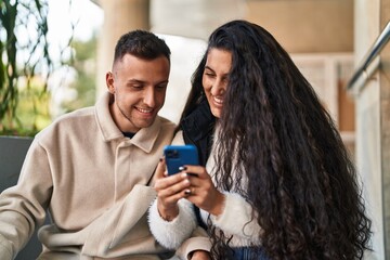 Poster - Man and woman smiling confident using martphone at street