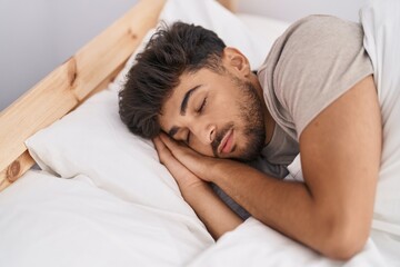 Wall Mural - Young arab man lying on bed sleeping at bedroom