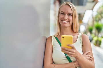 Sticker - Young blonde woman smiling confident using smartphone at street