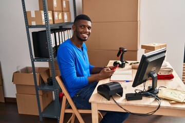 Sticker - Young african american man ecommerce business worker using smartphone at office