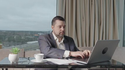 Poster - Happy businessman working on laptop in home office. financial investor working in the office. Accountant working on consolidated financial report of corporate operations.