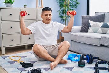 Poster - Young latin man using dumbbells training at home