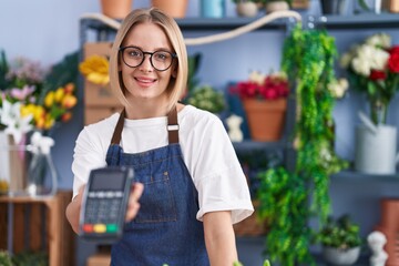 Poster - Young blonde woman florist smiling confident holding data phone at florist shop