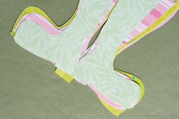 Wall Mural - pile of paper boot shapes on rough green paper