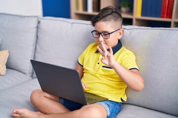 Sticker - Adorable hispanic boy having video call communicate with sign deaf language at home