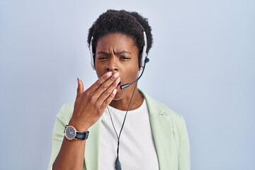 Wall Mural - African american woman wearing call center agent headset bored yawning tired covering mouth with hand. restless and sleepiness.