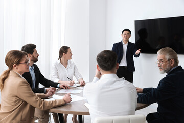 Sticker - Business conference. Group of people listening to speaker report near tv screen in meeting room