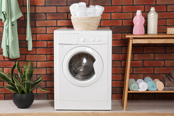 Wall Mural - Washing machine and wooden console table with terry towels indoors. Laundry room interior design