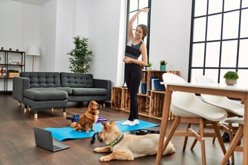 Sticker - Young hispanic woman smiling confident having online stretching class at home