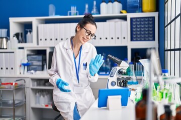 Canvas Print - Young caucasian woman scientist having video call at laboratory