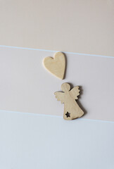 Wall Mural - wooden heart and angel ornaments on beige paper pad with paint chip element - macro lens, particular focus