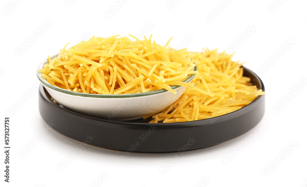 Bowl and plate of raw vermicelli pasta on white background