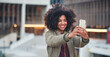 © moose/peopleimages.com - Black woman, city and selfie with afro, phone or smile for social media profile picture. Happy gen z girl, influencer or smartphone for blog, post or networking app on rooftop balcony for travel
