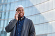 © moose/peopleimages.com - Phone call, city and smile, Islamic man talking on cell outside office building, happy guy in Turkey. Technology, communication and 5g, Muslim businessman with smartphone, happiness and conversation.