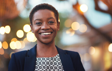 Smile, confident black woman and portrait in a city with bokeh, lights and blurred background space. Face, traveller and happy African American person in town for fun, break or trip on the weekend