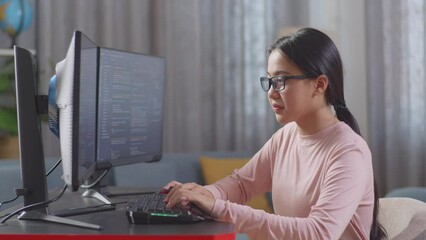 Asian Teen Girl Programmer Creating Innovative Software Engineer Developing App, Program, Video Game On Desktop Computer At Home. Terminal With Coding Language 

