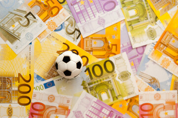 soccer ball and money, sport as business concept