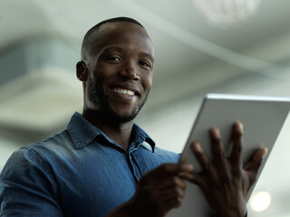 Fototapete - Smile, confidence and portrait of black man with tablet for email, sales or global networking. Research, happy company leader with vision and online communication in b2b management at startup office.
