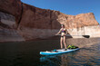 © Cavan Images - Woman paddleboardingÂ in Lake Powell, Utah, USA