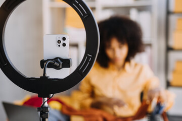 Diverse female fashion designers at work with tailor centimeters on necks and holds tablet and smartphone. independent creative design business. in studio