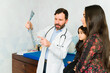 © AntonioDiaz - Pediatrician talking about tomography results to a family