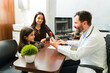 © AntonioDiaz - Adorable child patient receiving a candy at the pediatrician