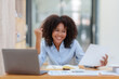 © amnaj - Businesswoman raising her hand in congratulation with document and laptop computer
