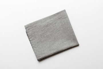 Wall Mural - top view with gray kitchen napkin isolated on table background. Folded cloth for mockup with copy space, Flat lay. Minimal style