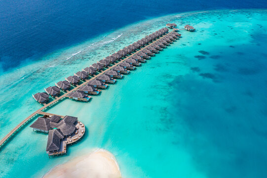 maldives paradise island. tropical aerial landscape, seascape with jetty, water bungalows villas wit