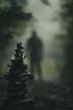 stone cone in a foggy forest, scary shadow of a man