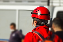 Unknown Back Of A Search And Rescue Worker In Front Of Blurred Building