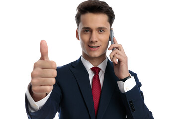 businessman talking on the phone and giving a thumbs up