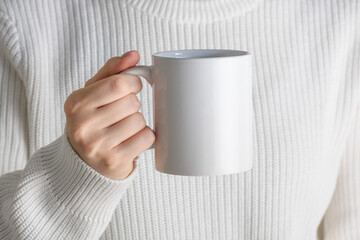 female hands holding white mug mockup with blank copy space for your advertising text message or pro