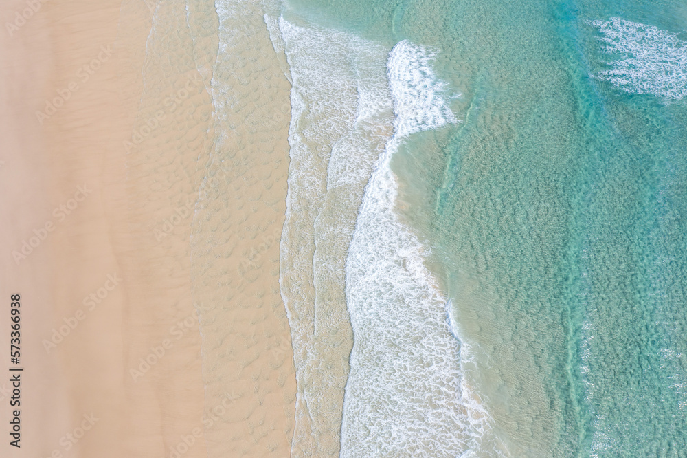 Aerial view of a beach with idyllic tropical blue water and gentle ...