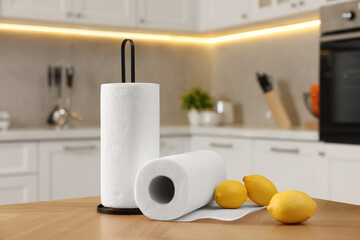 Wall Mural - Rolls of white paper towels and lemons on wooden table in kitchen