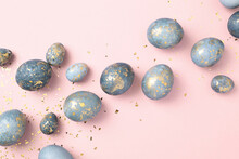 Blue Easter Eggs On Pink Background With Gold Confetti. Chic Easter Greeting Card. Easter Celebration.