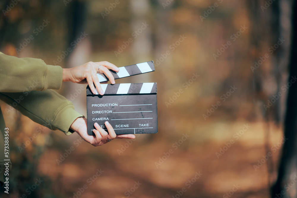 Director Holding a Cinema Slate in Outdoors Set
Independent filmmaker using natural light and resources to produce videos
