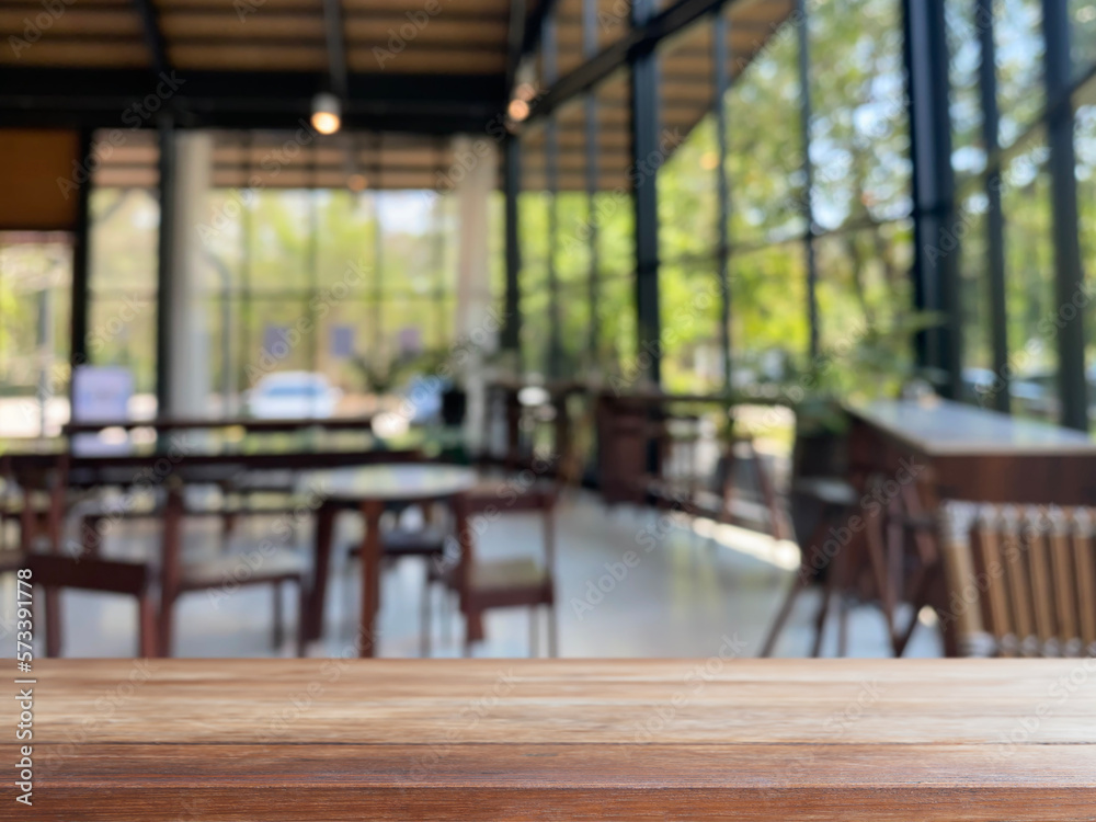 Empty wood table top and blurred coffee shop and restaurant interior ...