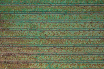 Rusted corrugated green aluminum panel grunge background texture