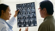 © Nattakorn - Young Asian woman doctor showing lung x-ray test results and describe to a senior patient in hospital. For cancer awareness month