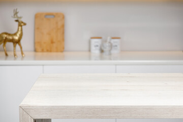 Empty Kitchen background. Light wooden table top, kitchen island, on blurred kitchen interior background. Display, template for advertising, presentation, montage products.