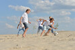 © aletia2011 - Family playing football on a beach in summer day
